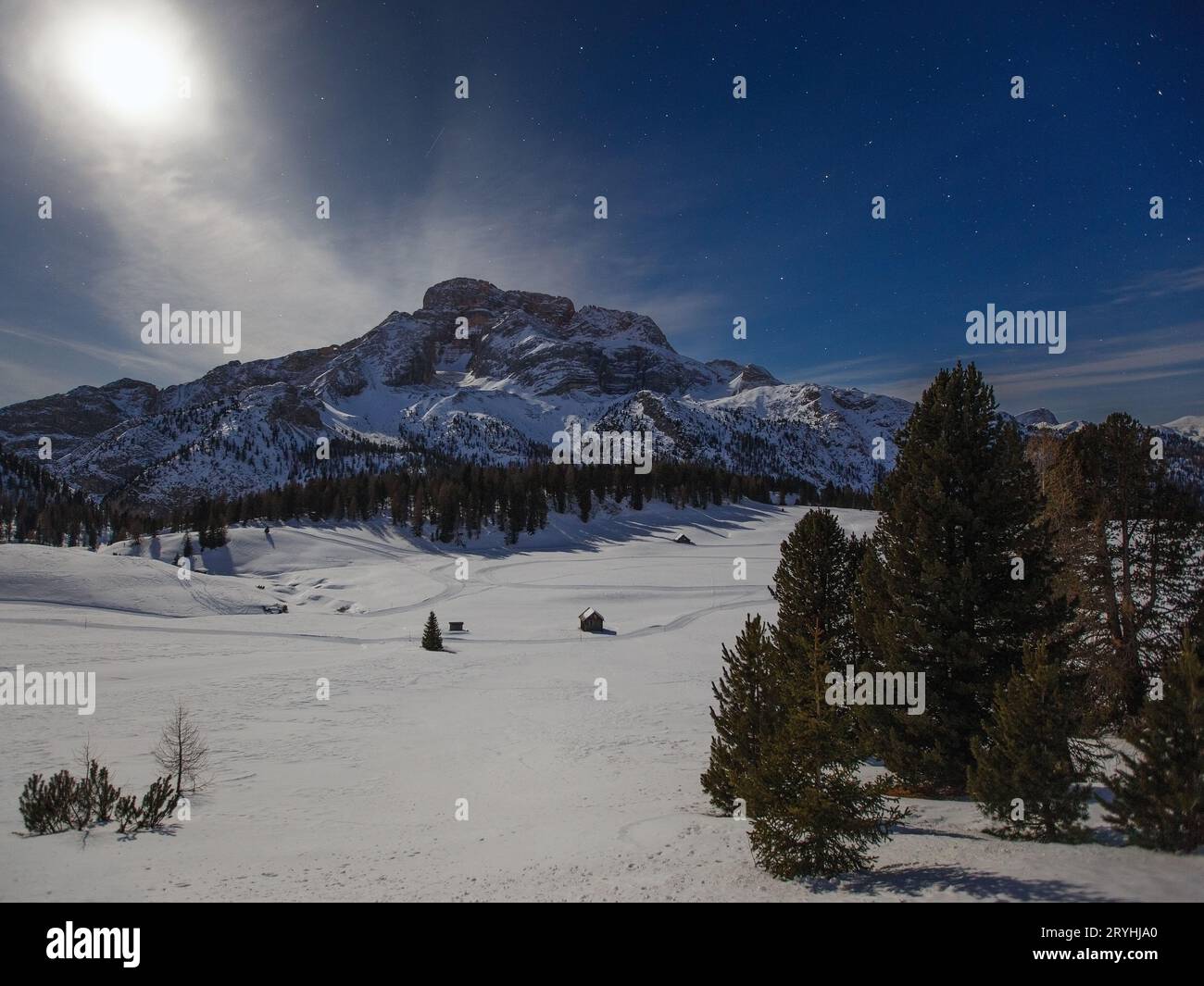 Moonlight illuminates the Prato Piazza plateau and Croda Rossa d'Ampezzo mountain. Winter night alpine landscape in Dolomites. Italian Alps. Europe. Stock Photo