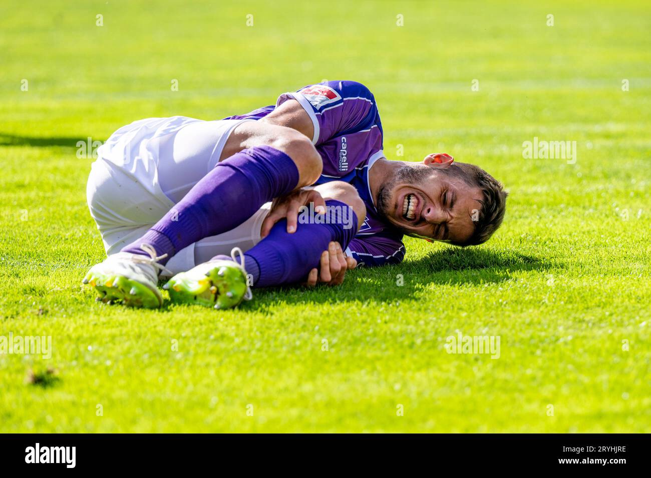 01 October 2023, Lower Saxony, Osnabrück: Soccer: 2. Bundesliga, VfL Osnabrück - 1. FC Kaiserslautern, Matchday 8, Stadion an der Bremer Brücke. Osnabrück's Bashkim Ajdini lies on the ground in pain. Photo: David Inderlied/dpa - IMPORTANT NOTE: In accordance with the requirements of the DFL Deutsche Fußball Liga and the DFB Deutscher Fußball-Bund, it is prohibited to use or have used photographs taken in the stadium and/or of the match in the form of sequence pictures and/or video-like photo series. Stock Photo