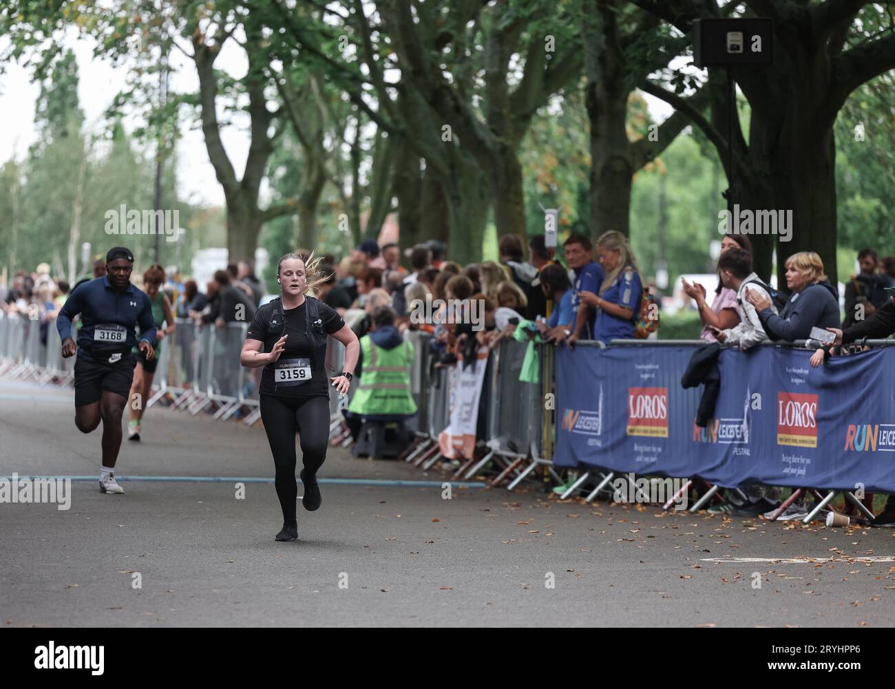 Runners in the Leicester Half Marathon 2023 going through the finish