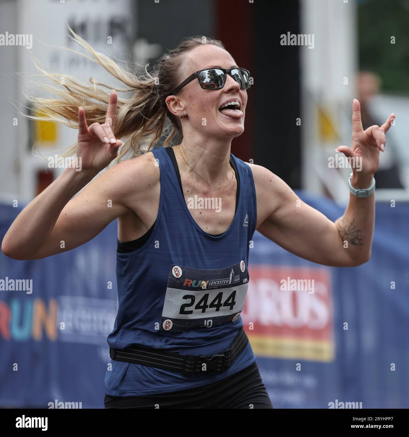 Runners in the Leicester Half Marathon 2023 going through the finish