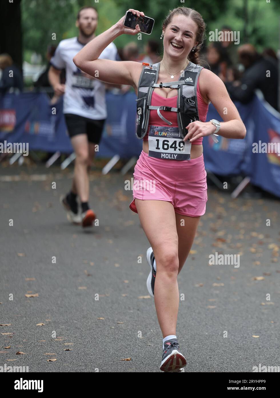 Runners in the Leicester Half Marathon 2023 going through the finish