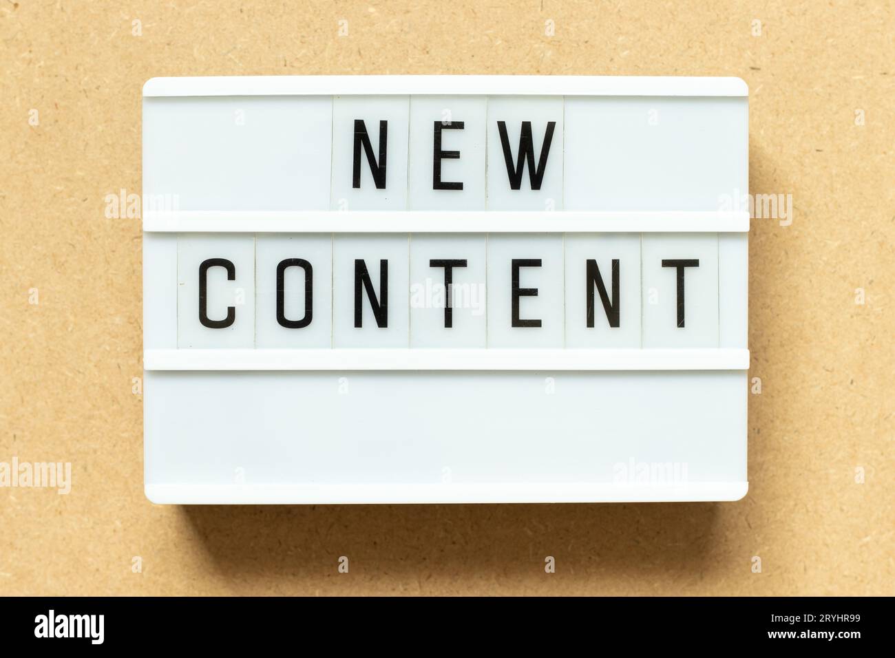 Lightbox with word new content on wood background Stock Photo