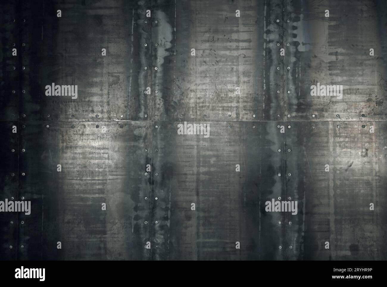 Rusty metal plates with bolt heads background Stock Photo