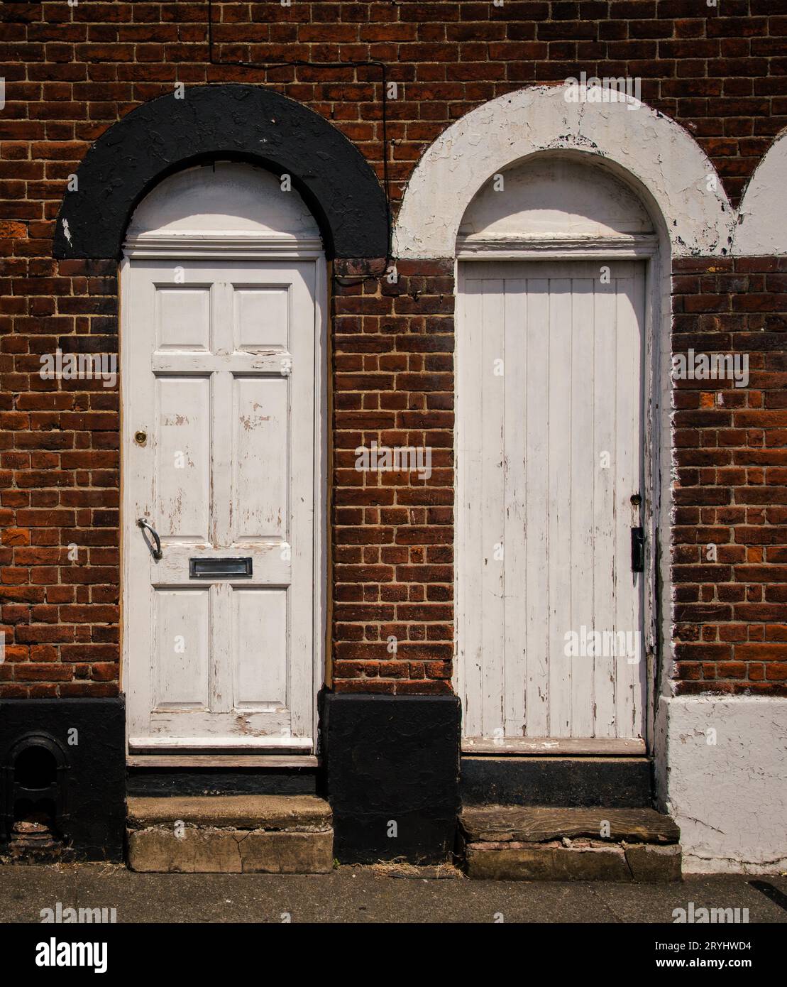 Traditional british village houses exteriors with closed door and brick wall Stock Photo