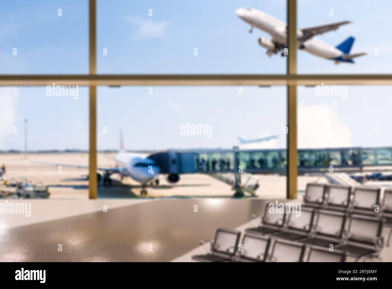 Empty airport terminal hall with an airplane in the background. Stock Photo