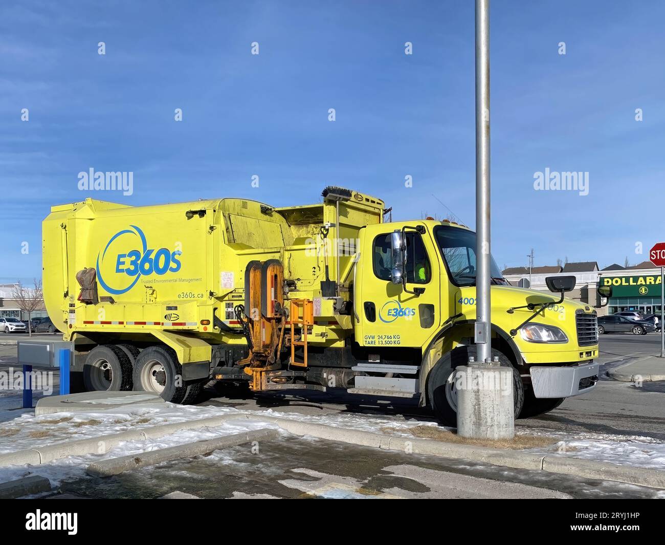 Calgary, Alberta, Canada. Feb 21, 2023. A environmental management 360 Solutions Ltd yellow truck during the winter parked on th Stock Photo