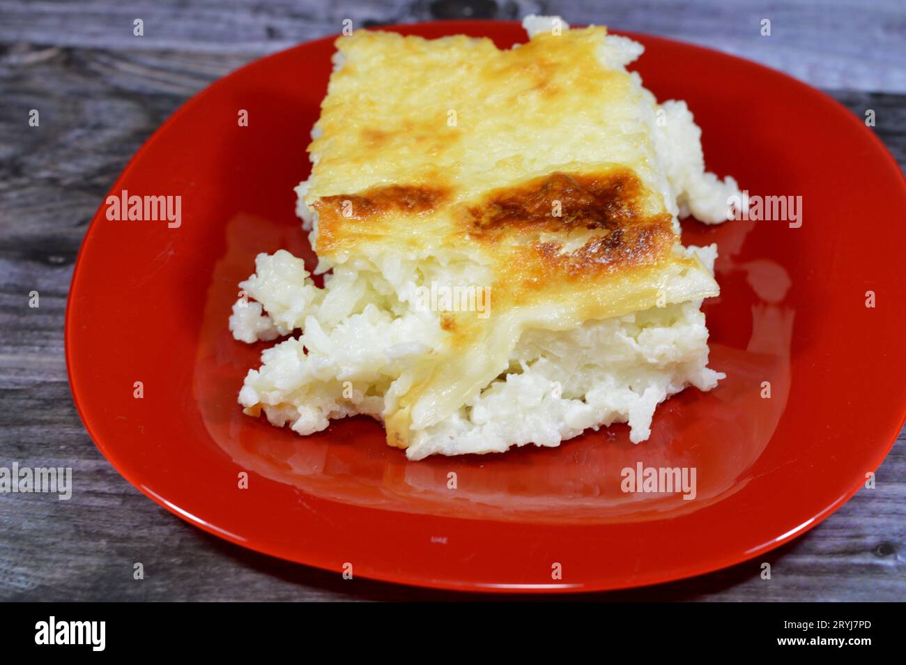 Baked Egyptian rice or Roz muammar's combination of rice, fresh cream, milk, ghee or butter, a very popular Egyptian dish, a simple, sumptuous Egyptia Stock Photo