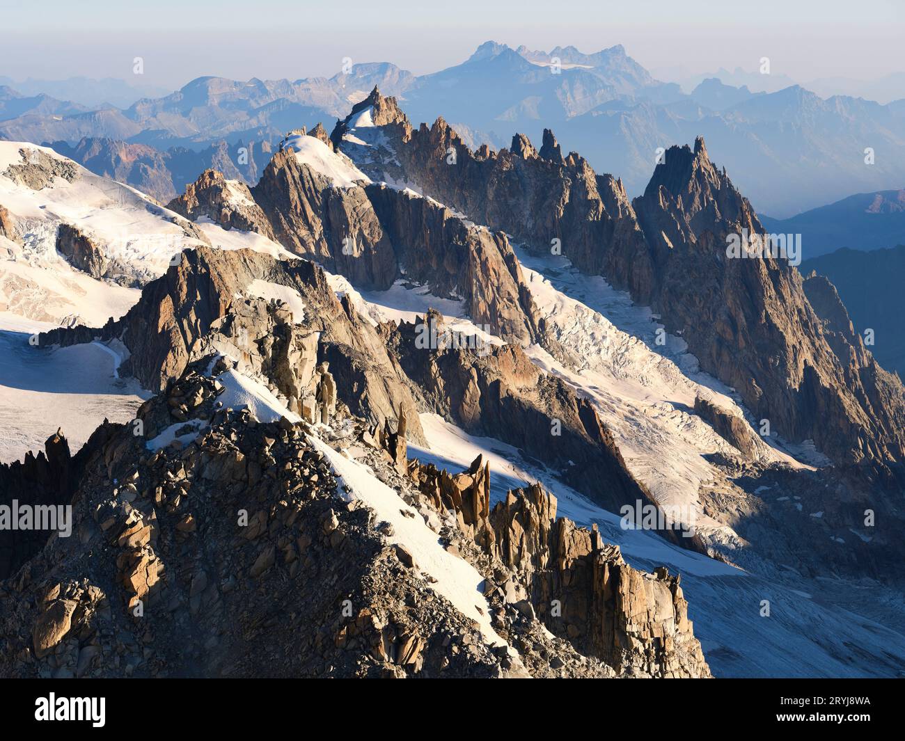 AERIAL VIEW. The jagged rock formations of (front to back) La Tour Ronde, Gros Rognon and Aiguilles de Chamonix Mont Blanc. Haute-Savoie, France. Stock Photo