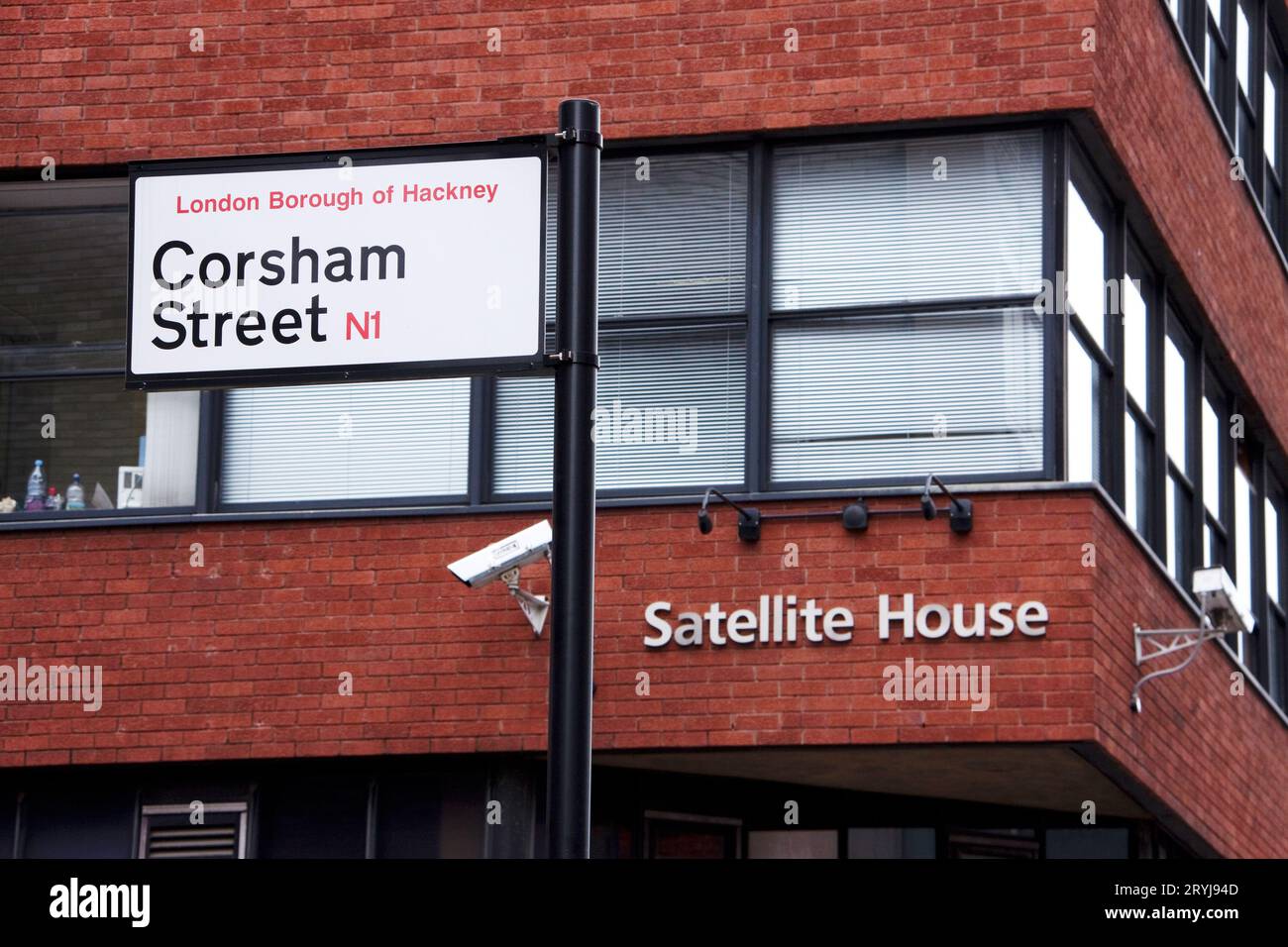 Corsham Street sign in London Borough of Hackney with Satellite House in the background and group 4 CCTV camera visible Stock Photo