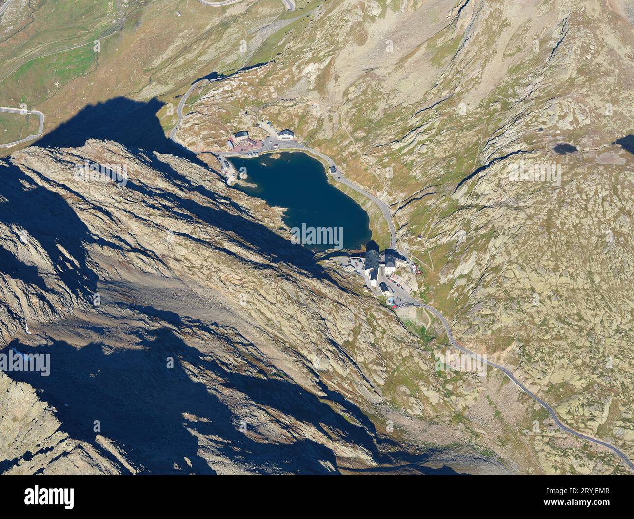 AERIAL VIEW. Grand Saint-Bernard Pass (2469m) and international border at the lake between Italy (second half of the lake and behind) and Switzerland. Stock Photo