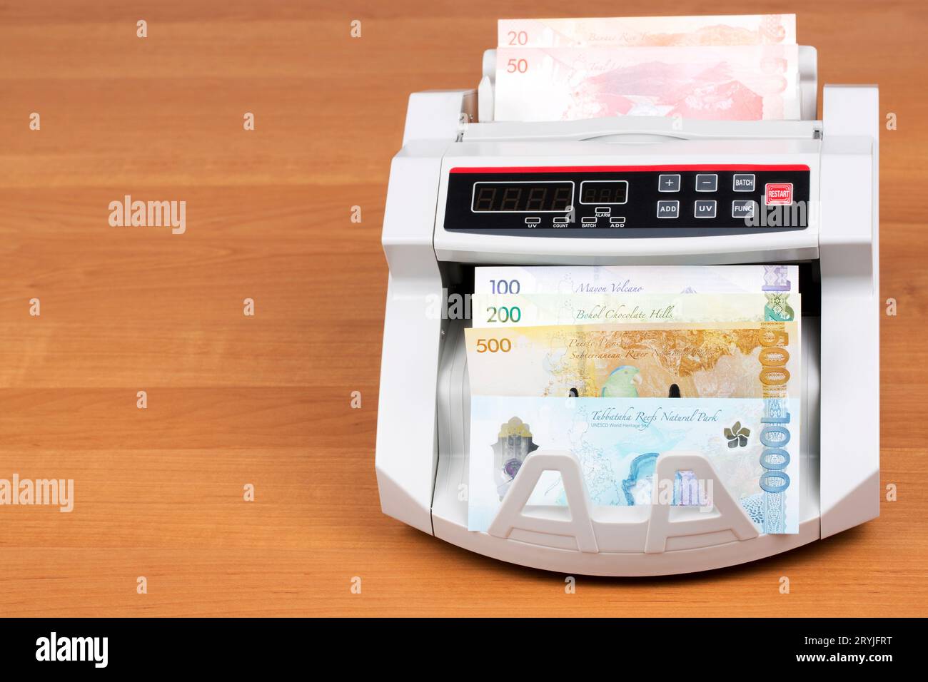 Philippine money in a counting machine Stock Photo