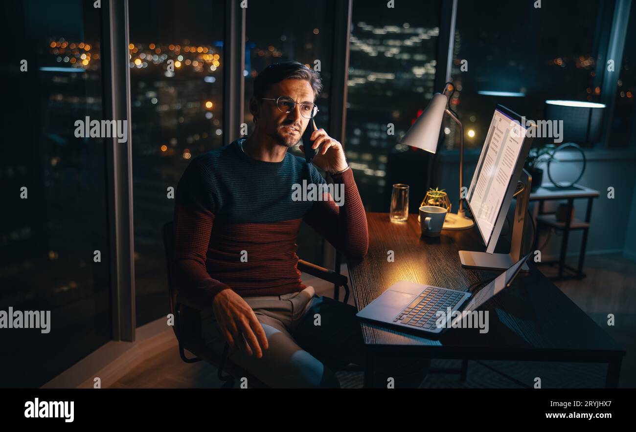 A dedicated business professional, working from home, multitasks during ...