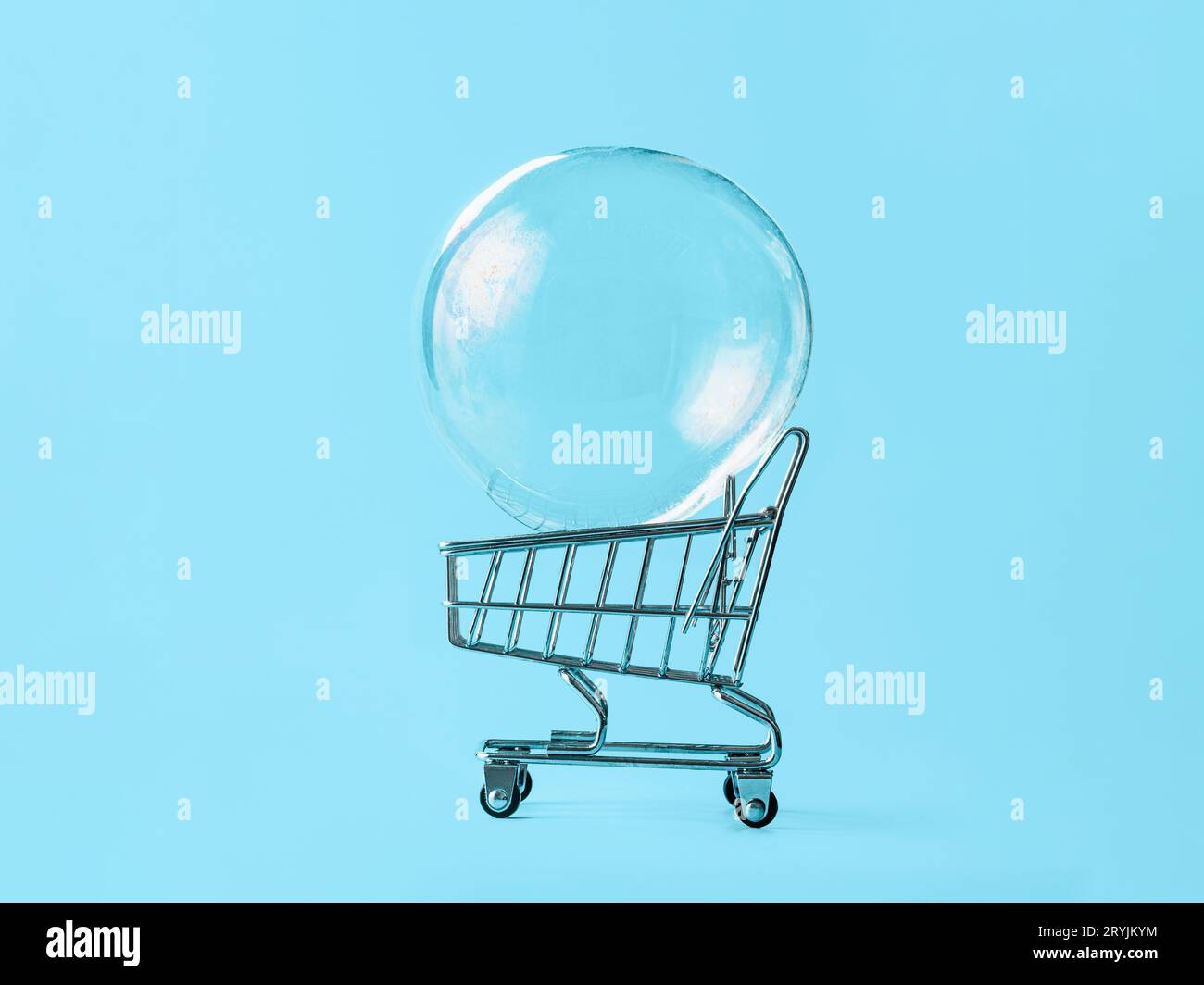 Shopping cart with soap bubble on blue background Stock Photo