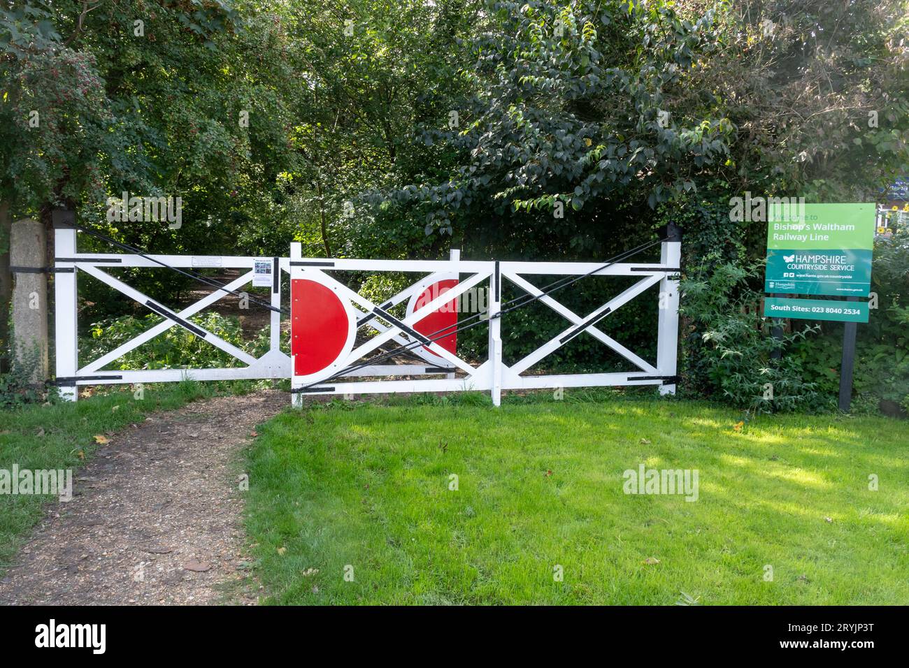 Pair of level crossing gates leading to disused railway track in Bishop's Waltham close to the Old Station Roundabout, Hampshire, England, UK Stock Photo