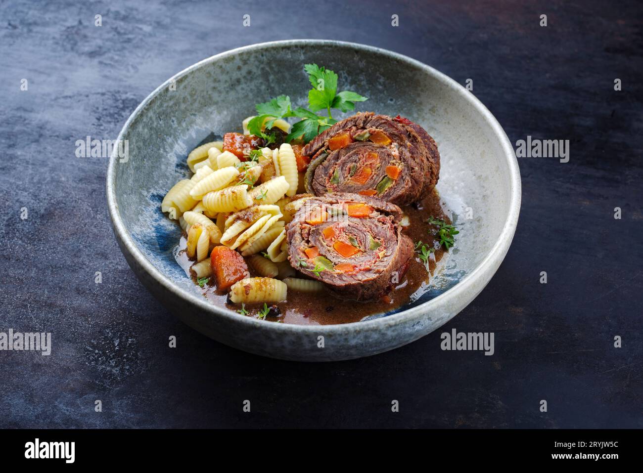 Traditional slow cooked German wagyu beef roulades with gnocchetti sardi pasta served in spicy gravy sauce as close-up on a Nord Stock Photo