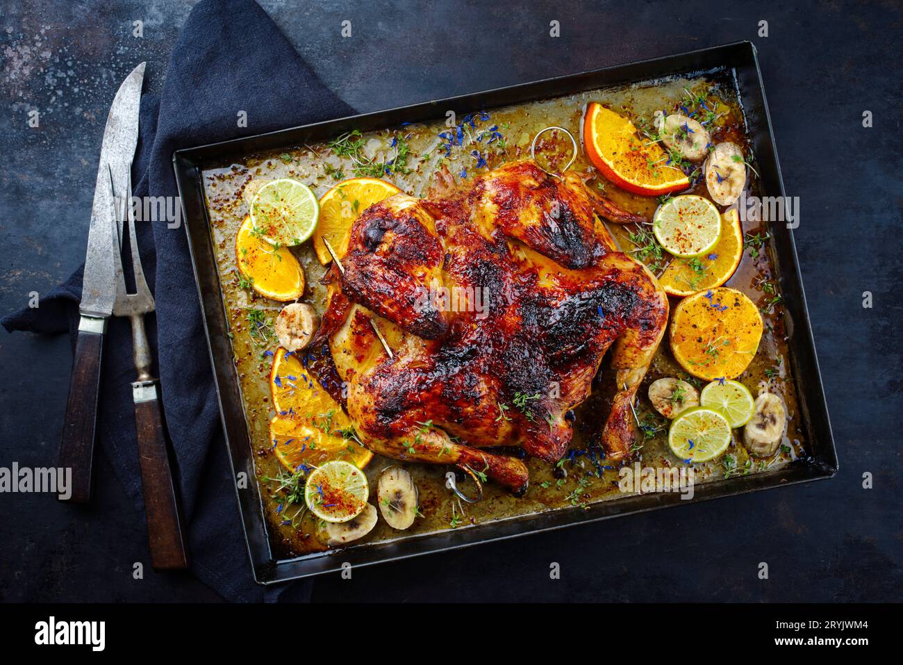 Traditional barbecue spatchcocked chicken al mattone chili with orange Stock Photo