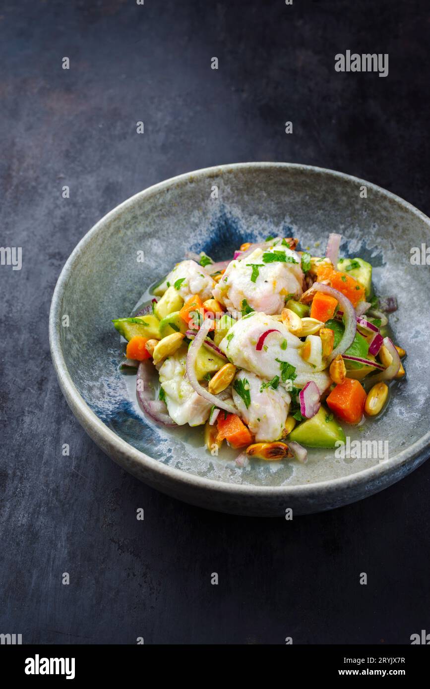 Traditional Peruvian gourmet ceviche sea bass filet piece with sweet