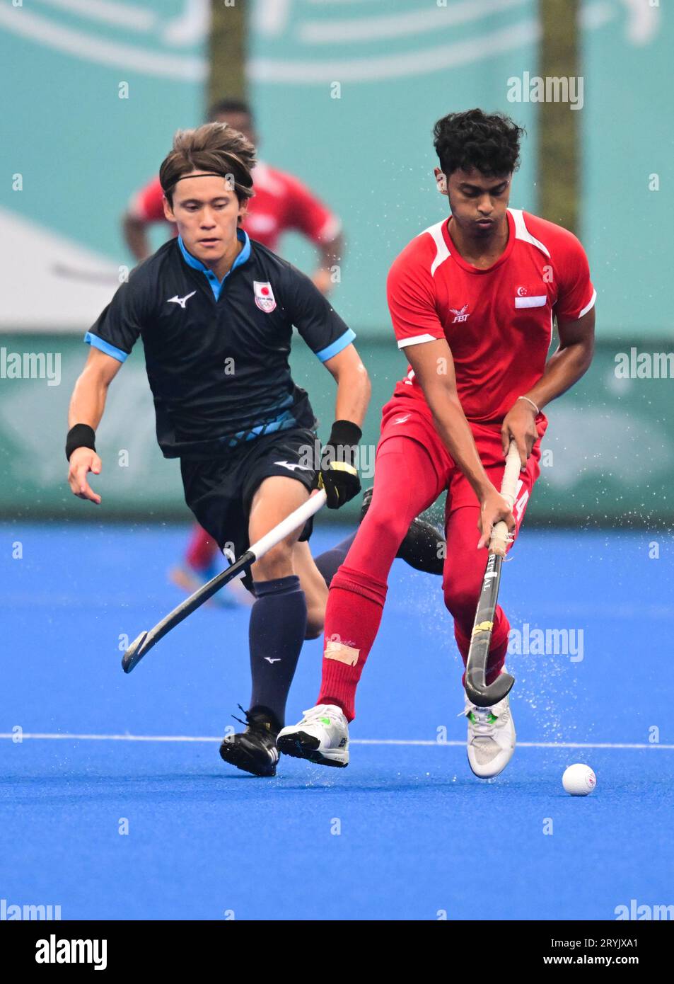 Yuma Nagai (L) of the Japan men hockey team and Rengasamy Dawnraj (R