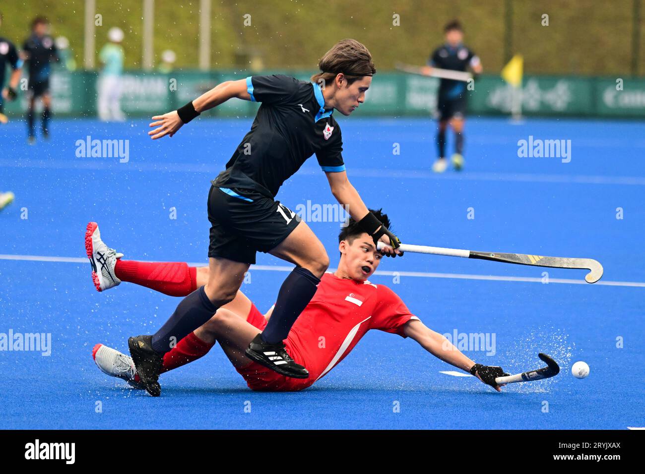 Yuma Nagai (L) of the Japan men hockey team and Ethan Yi Hao Tan (R) of