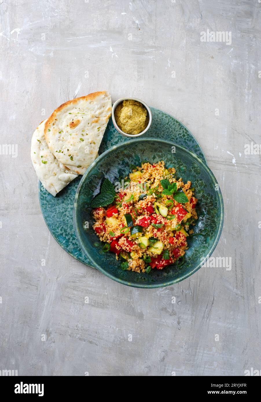 Traditional Moroccan vegetable couscous with pita bread and hummus