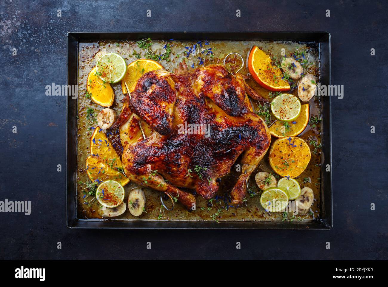 Traditional barbecue spatchcocked chicken al mattone chili with orange Stock Photo