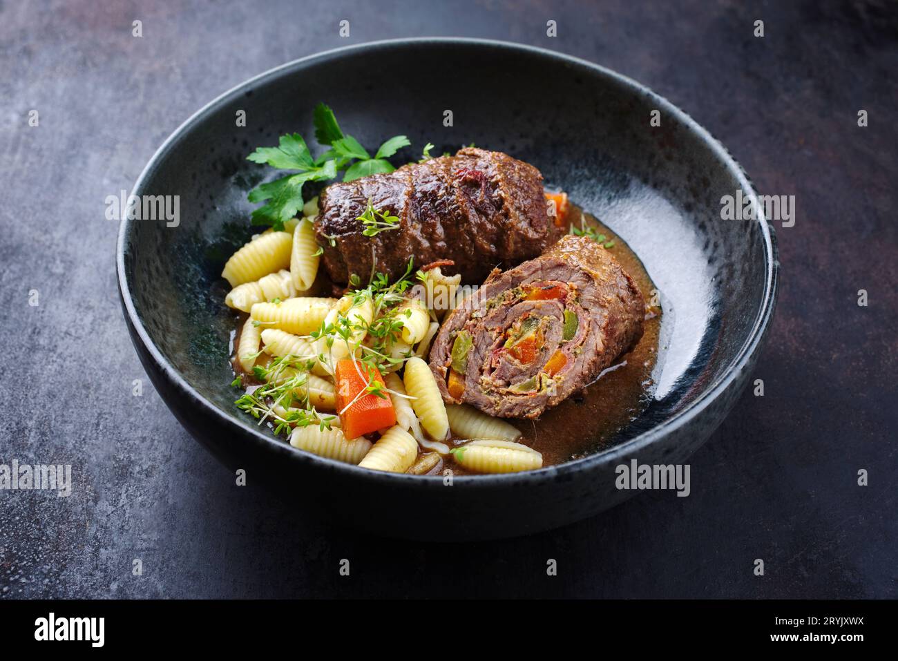 Traditional slow cooked German wagyu beef roulades with gnocchetti sardi pasta served in spicy gravy sauce as close-up on a Nord Stock Photo