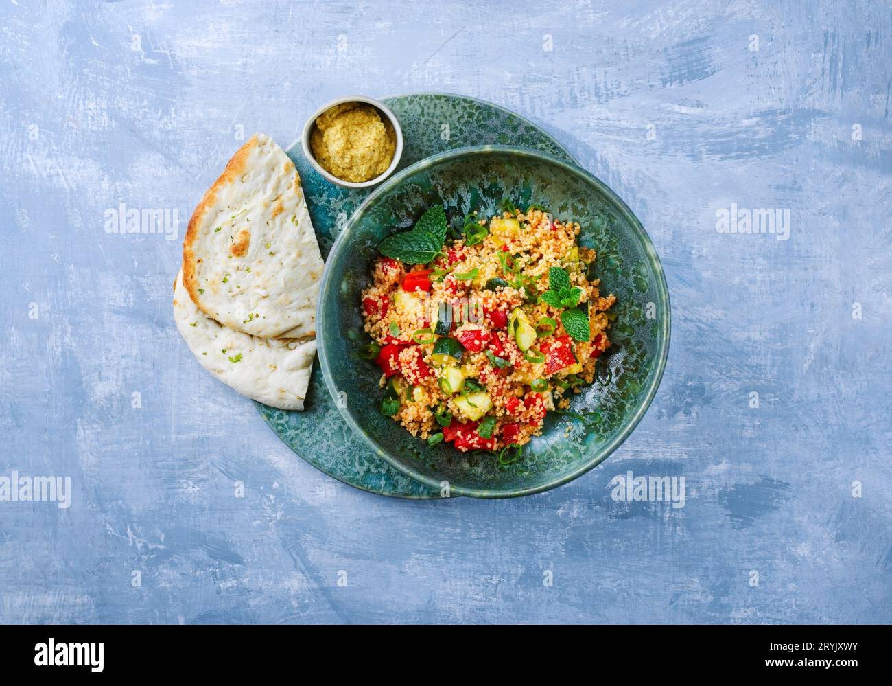Traditional Moroccan vegetable couscous with pita bread and hummus