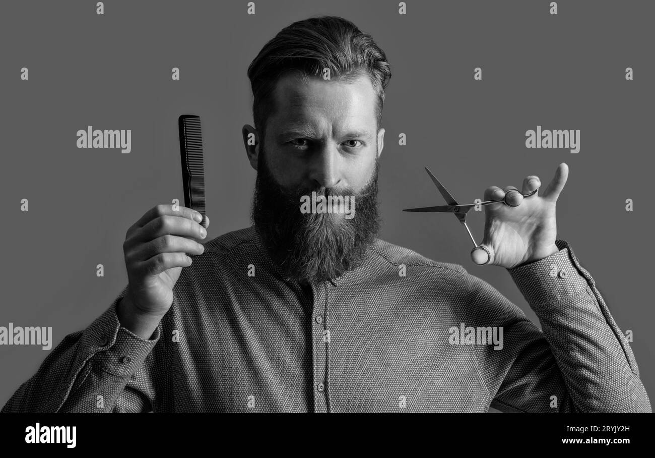man holding barber scissors and comb. barber with hairstyle. barber man