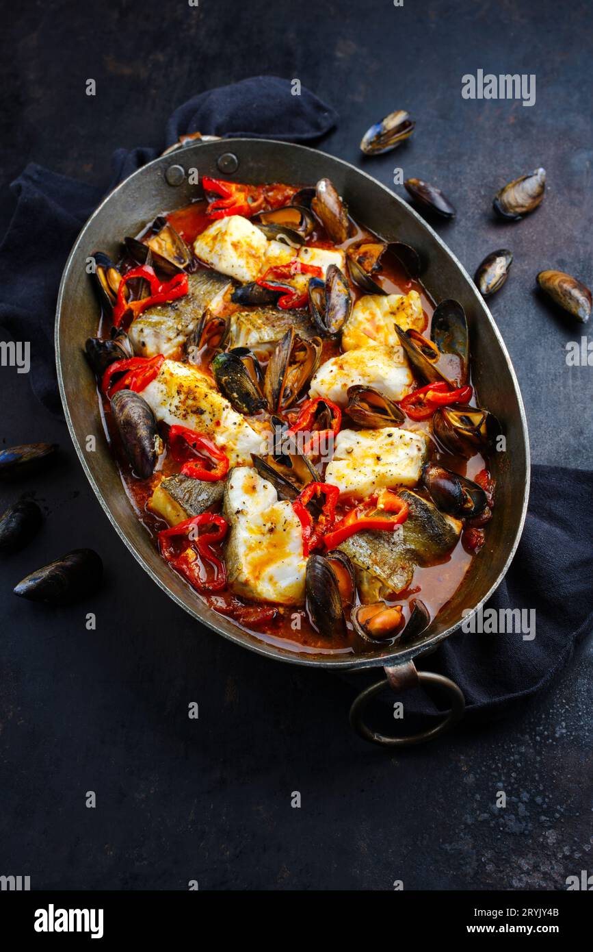 French Style Cod Fish Traditional French seafood bouillabaisse with cod fish and mussels in ...
