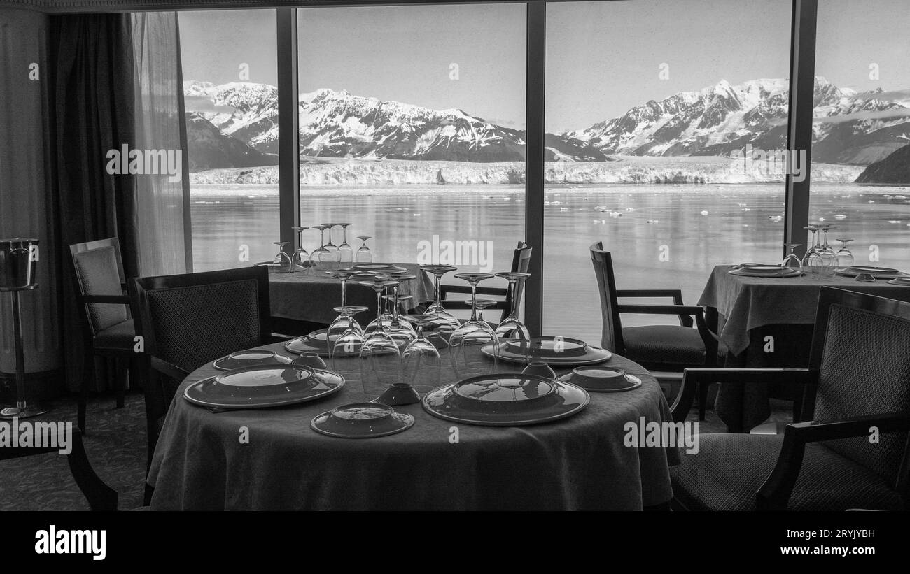 Empty restaurant seating interior with panoramic windows at scenic glacier bay nature Stock Photo