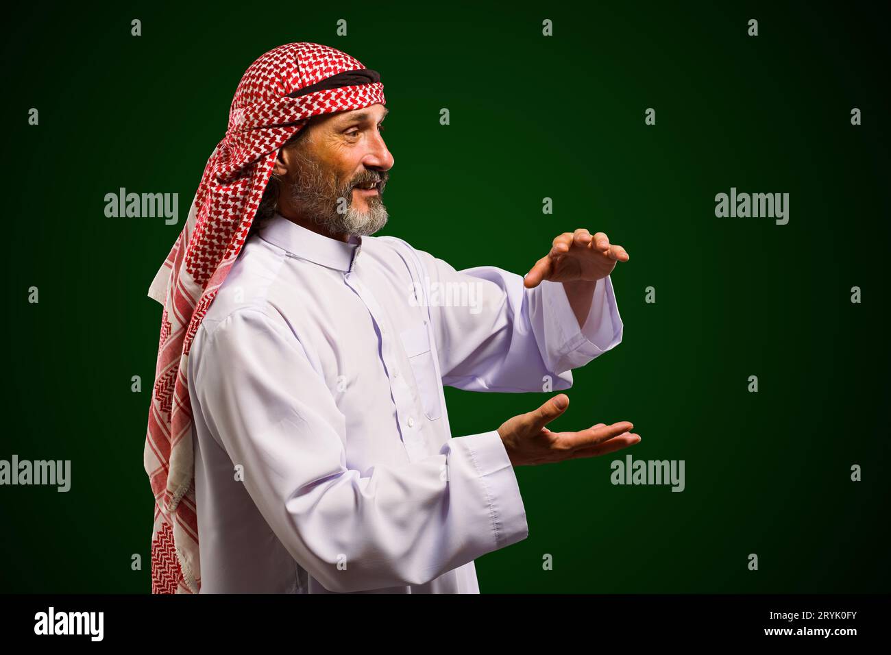 Arab sorcerer forming energy ball with his hands, performs mystical ritual. Mystical and supernatural aspects of traditional Ara Stock Photo