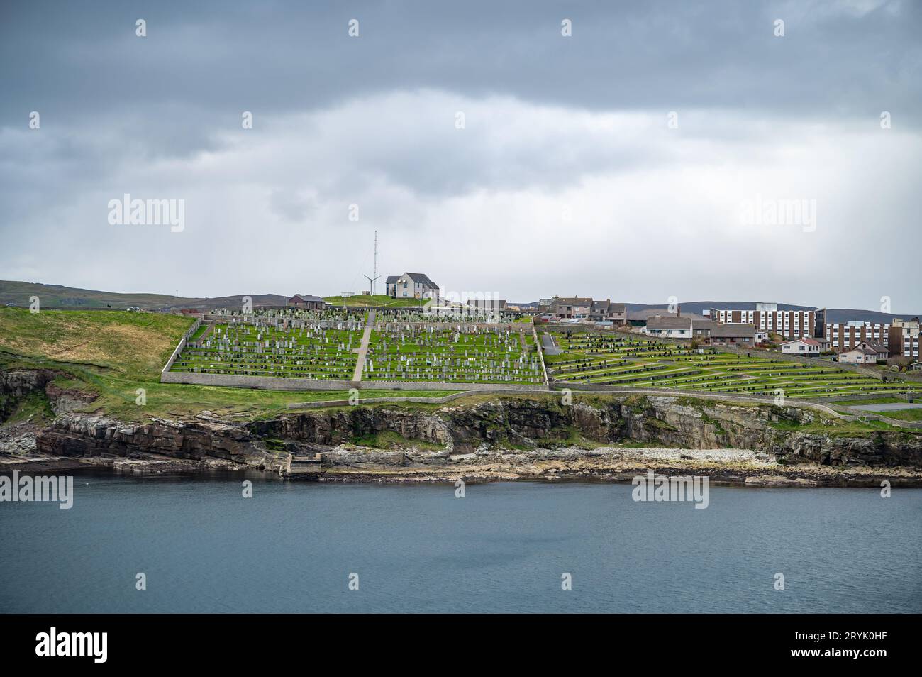 Shetland Islands Cityscape and old graveyard with sea in front, wide