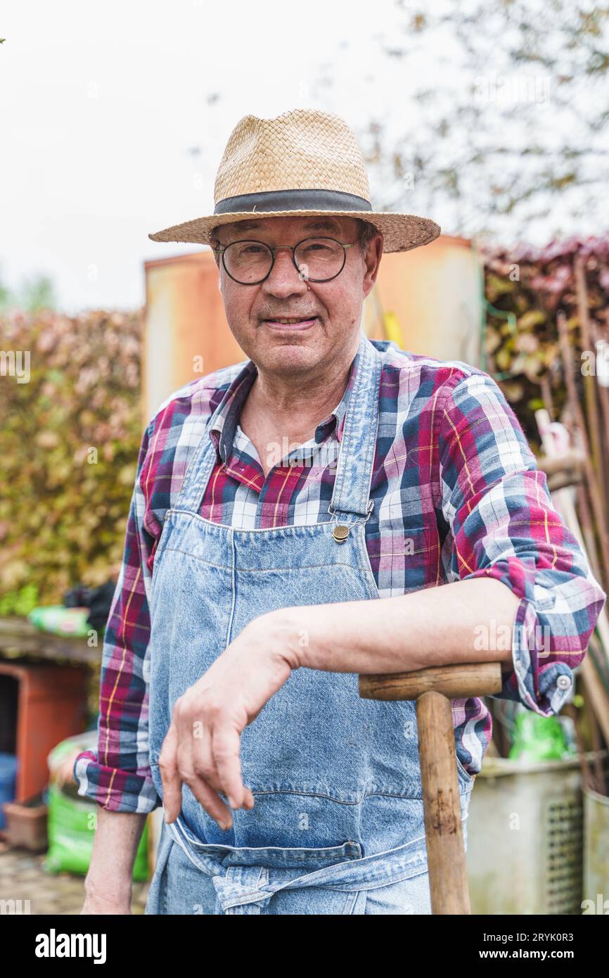 Elderly Farmer Leaning on His Hoe Portrait of a 65yearold farmer