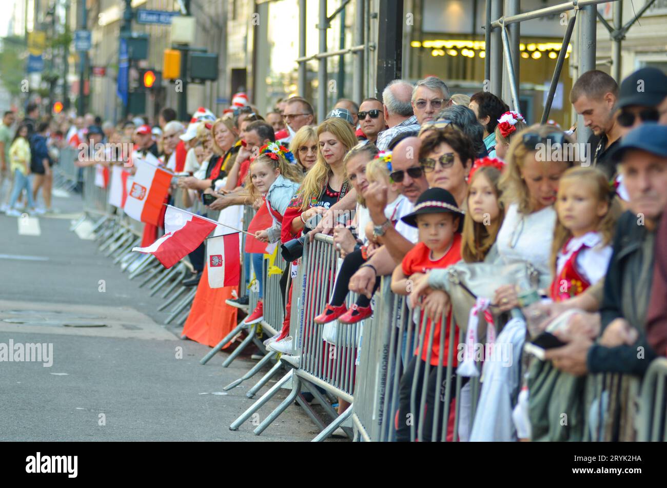 New York, NY, United States. 1st October, 2023. Specatators of all ages holding Polish flags during the 86th Annual Pulaski Day Parade along Fifth Avenue, New York City. Credit: Ryan Rahman/Alamy Live News Stock Photo
