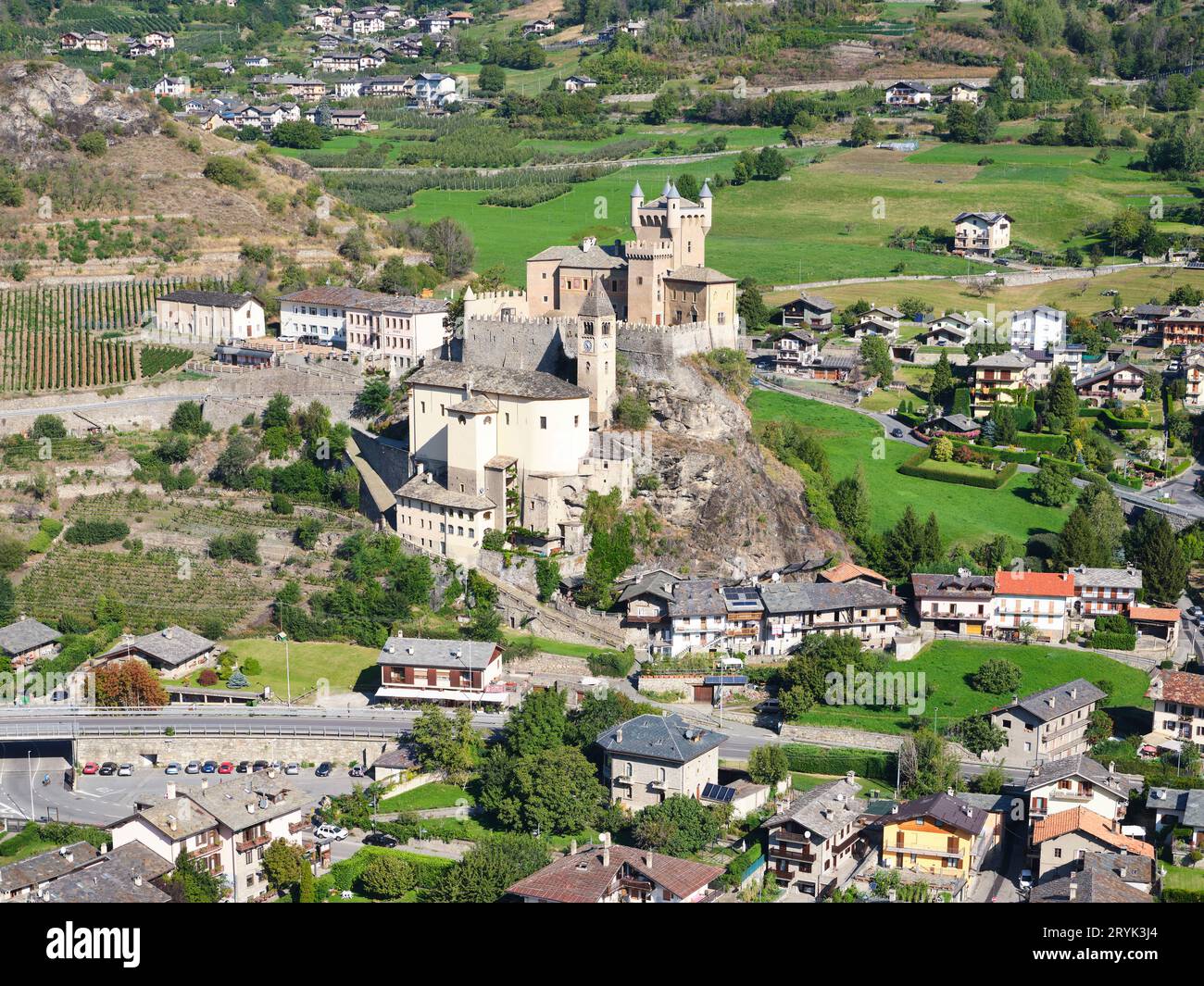 AERIAL VIEW. Saint-Pierre Castle and Parish Church on a rocky outcrop. Saint-Pierre, Aosta Valley, Italy. Stock Photo