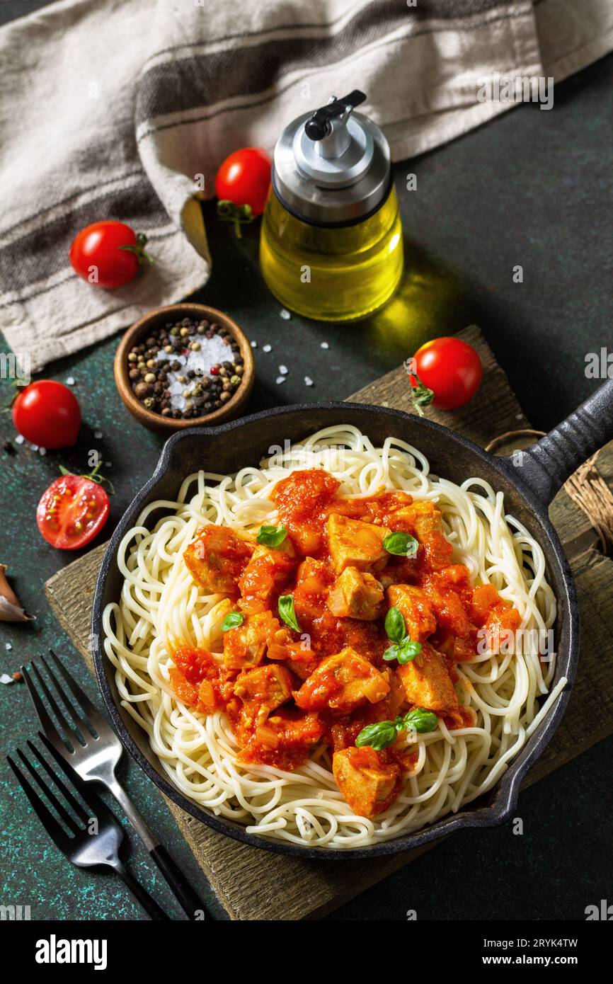Healthy food, Italian pasta. Spaghetti with chicken and vegetables in tomato sauce in a cast