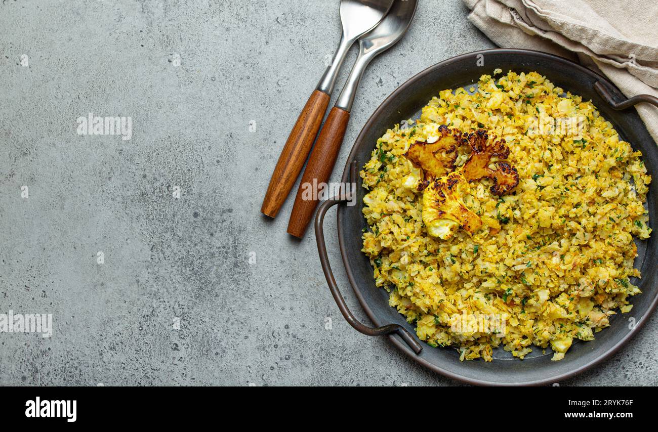 Fried cauliflower rice or couscous with dill on plate, healthy low
