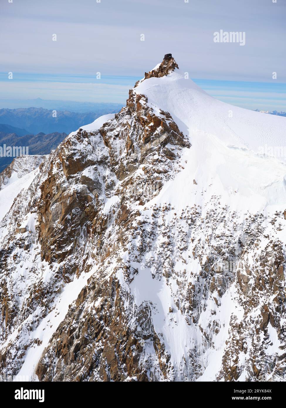 AERIAL VIEW. Capanna Regina Margherita is Europe's highest mountain hut at an elevation of 4554m at the summit of Punta Gnifetti (Signalkuppe). Italy. Stock Photo