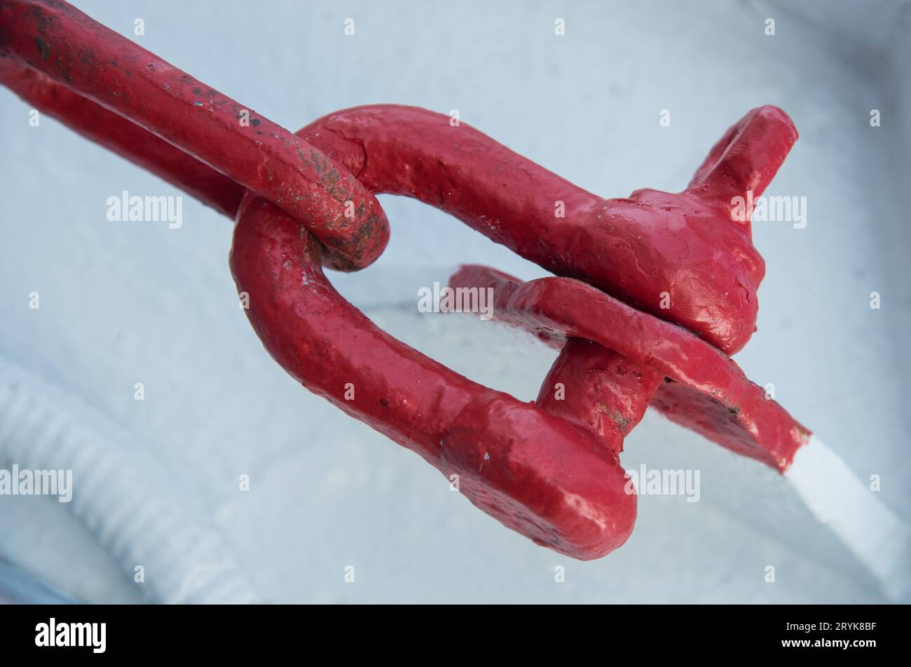 Boat safety metal fastener. Red Industrial metal chain holder Stock Photo
