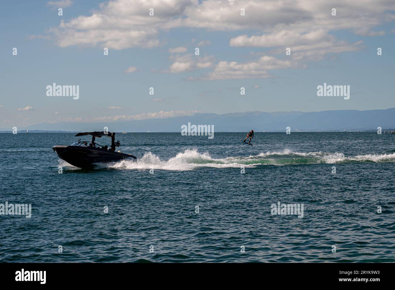 Ouchy, Lausanne, Vaud Canton, Switzerland - 24 September, 2023 : Motorboat with people wakeboarding in Lake Geneva. Stock Photo