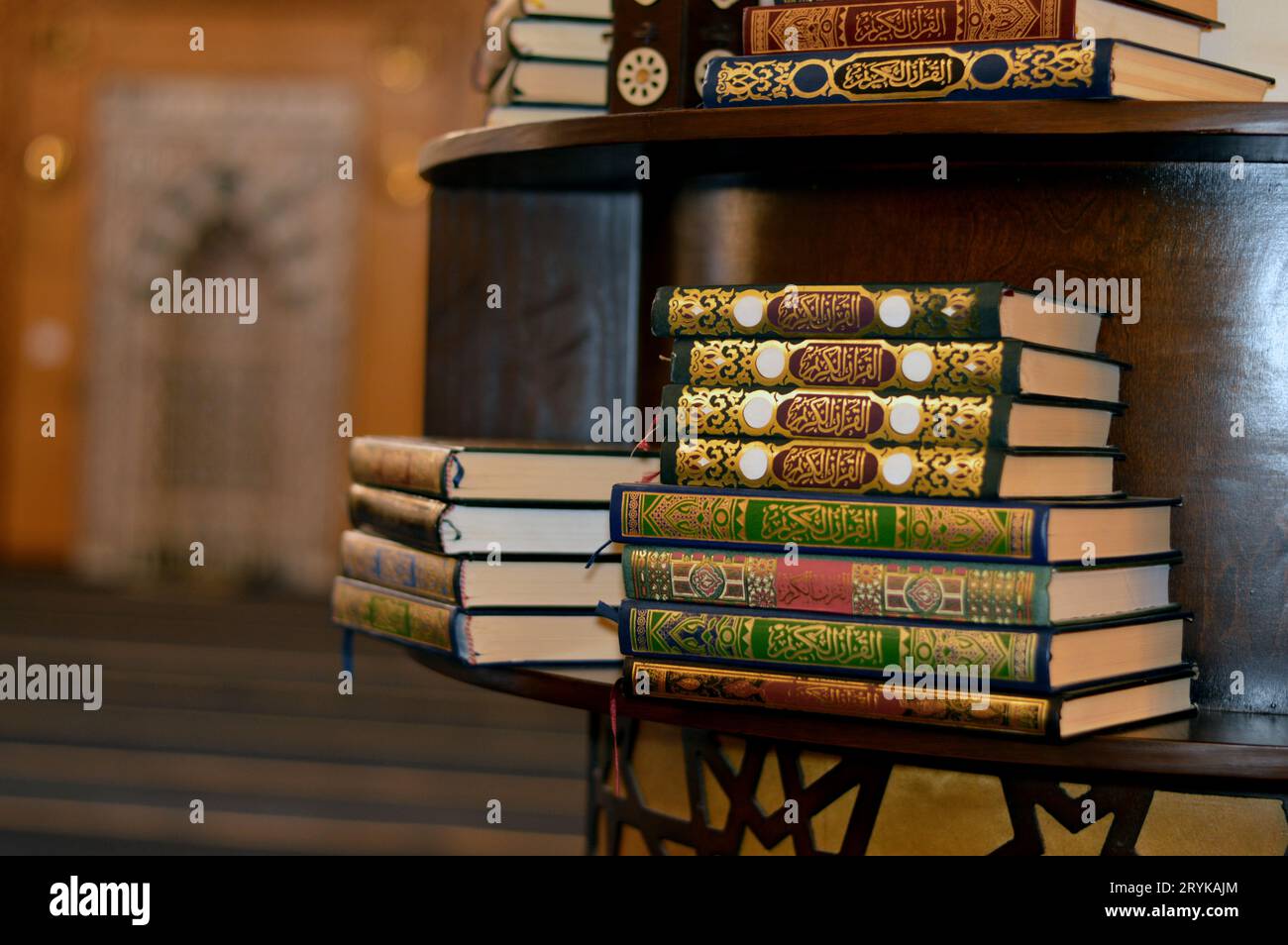 Holy Quran books in a row standing on a wooden shelf inside a mosque