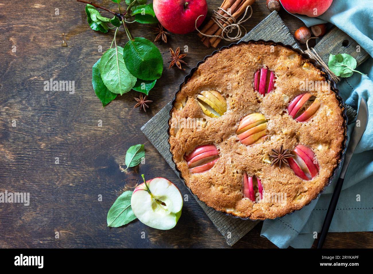 Apple baking gluten free seasonal. Autumn pie with apples, hazelnut and cinnamon on a wooden table. Top view flat lay background Stock Photo