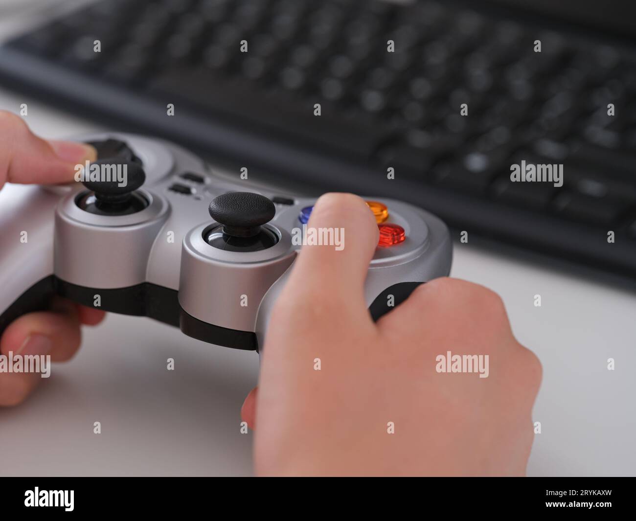 A young man playing video games using a gamepad. Close up. Stock Photo