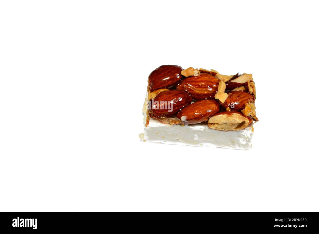 Roasted almonds on top of Arabic sweet delicious Noga, Egyptian cultural desserts of prophet