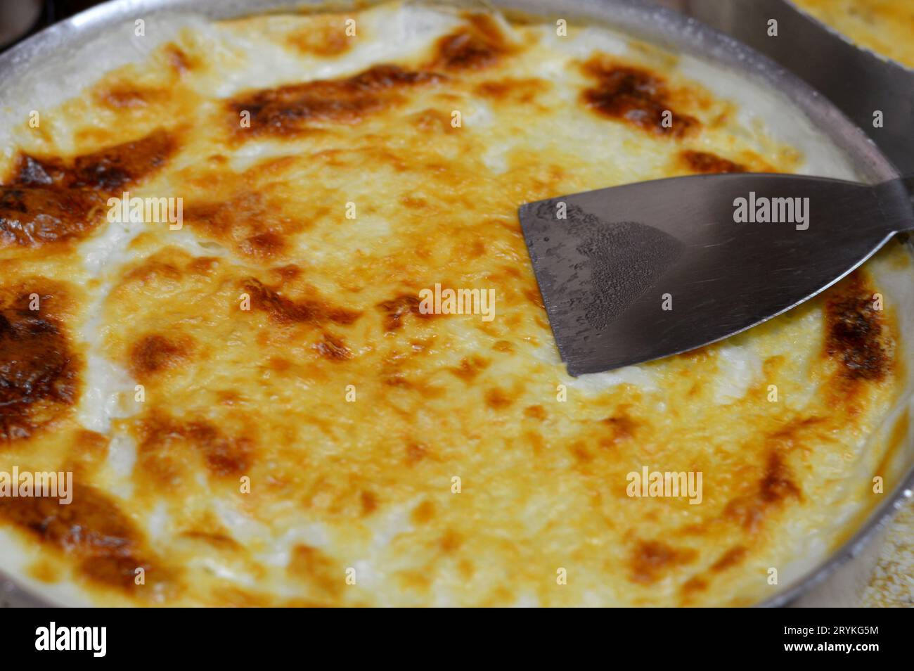 Baked Egyptian rice or Roz muammar's combination of rice, fresh cream, milk, ghee or butter, a very popular Egyptian dish, a simple, sumptuous Egyptia Stock Photo