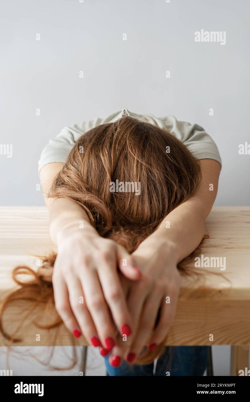 Woman with long hair lies on the table Stock Photo
