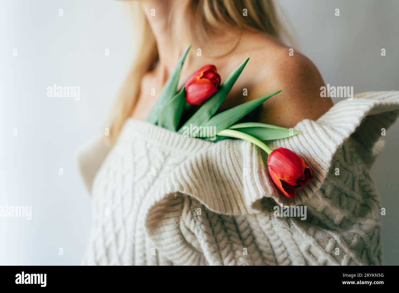 Close-up of tulips heads decorate the female body. Stock Photo