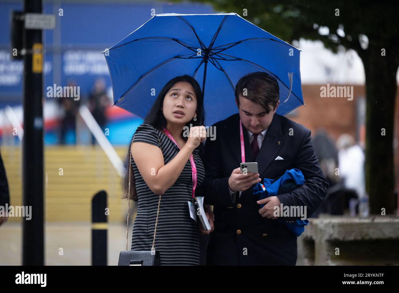 Manchester on Sunday 1st October 2023. Tory conference goers shelter from the rain during the Conservative Party Conference at Manchester Central Convention Complex, Manchester on Sunday 1st October 2023. (Photo: Pat Scaasi | MI News) Credit: MI News & Sport /Alamy Live News Stock Photo