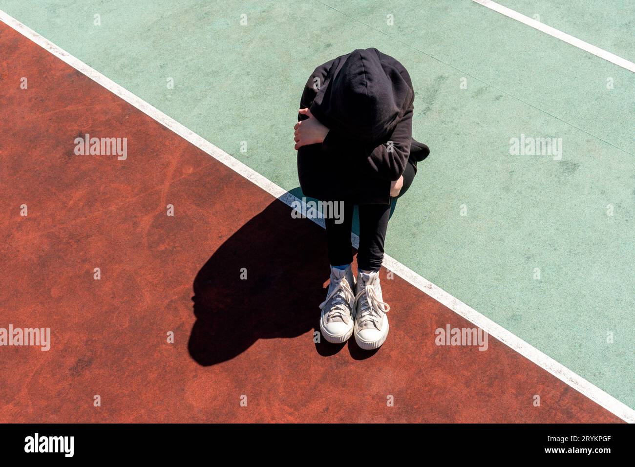 Depressed and hopeless teenage girl sitting alone Stock Photo - Alamy