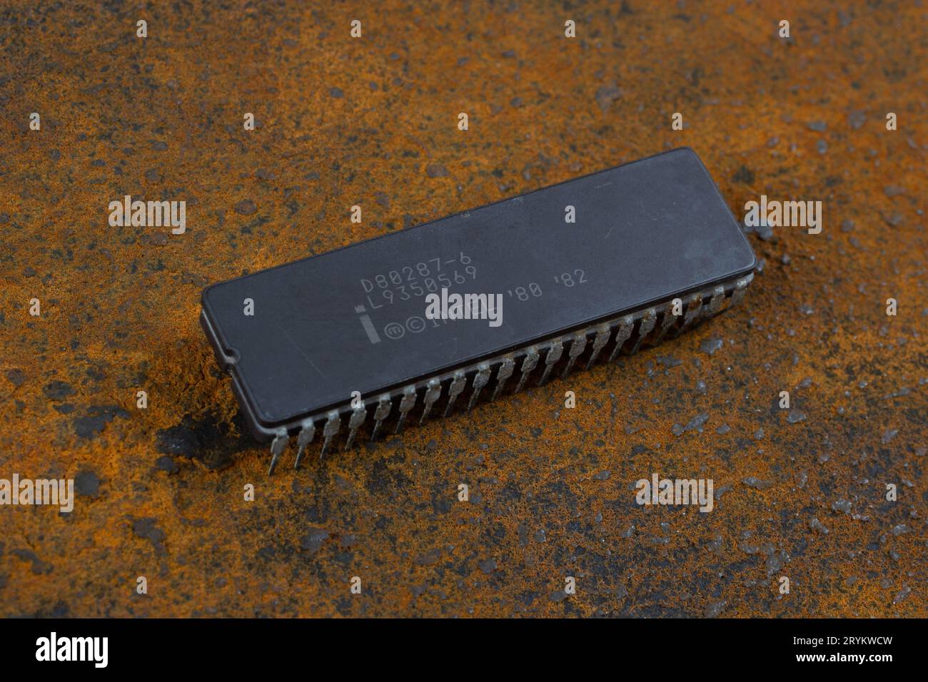KYIV, UKRAINE - August 2, 2023. Intel 287 floating-point unit coprocessor unit on rusty background. Stock Photo
